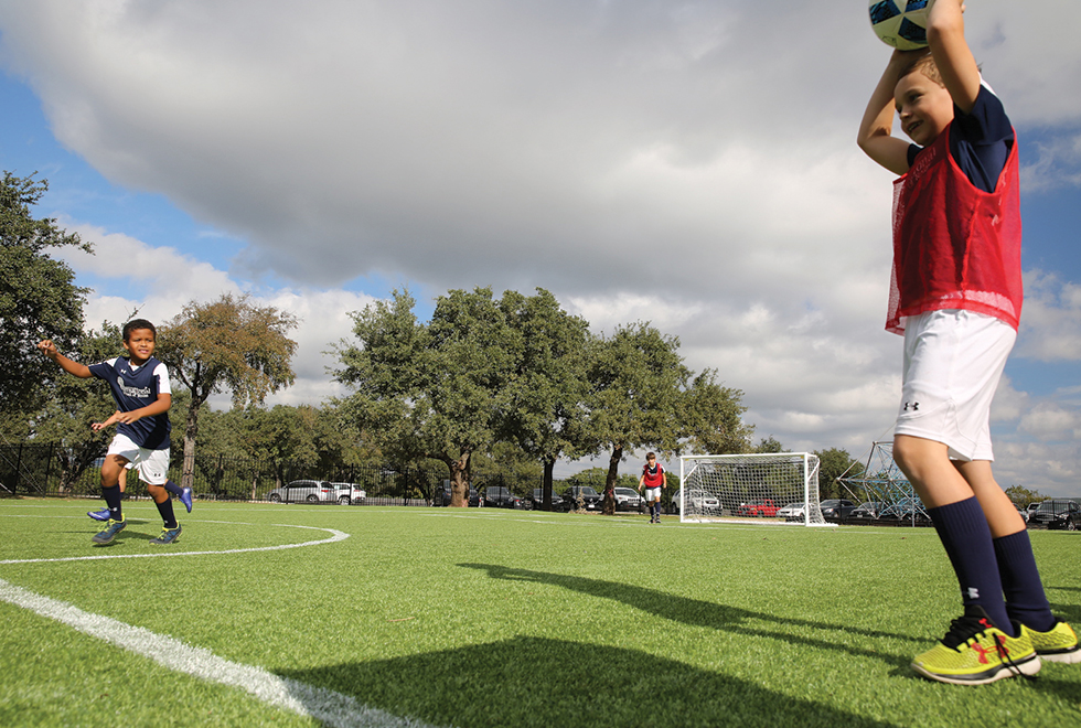 The IST soccer team during the exhibition game at the opening of their Kickabout field.