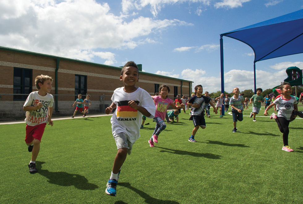Kids at D.H. Brent Elementary in Little Elm ISD enjoying their Kickabout playground built by Hellas Construction.